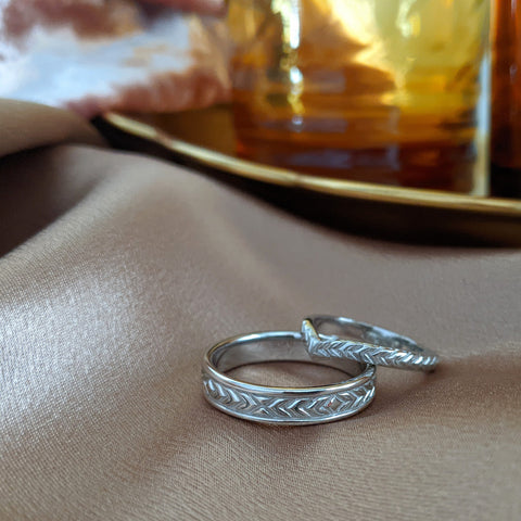 custom matching wedding rings on a piece of sand colored satin