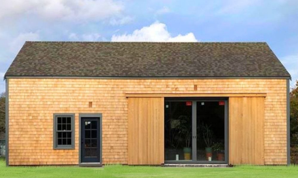 Modern garage or tiny house with cedar shingle siding, freshly installed.