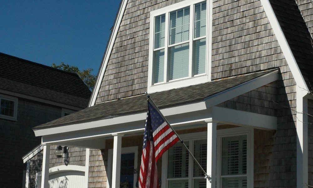 Cape cod house with naturally weathered, cedar shingles.