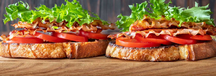 Simply The Best BLT Sandwich2 BLT Sandwiches sitting on a wood table