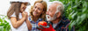 Grandpa Handing Granddaughter a tomato in the garden