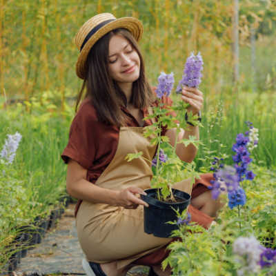 Woman holding potted flower start outside