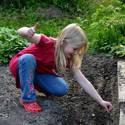 young girl planting seeds