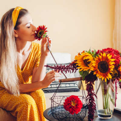 woman smelling sunflower