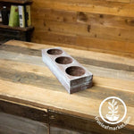 barnwood style planter box with three holes on table