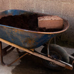 Wheelbarrow filled with soil to demonstrate how much soil a block will produce