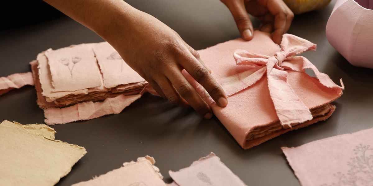 artisan folding and packaging an artisanal gift, handcrafted wrapping paper
