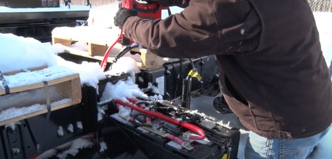 Goodall jump pack powering up dead battery on tractor trailer in the snow