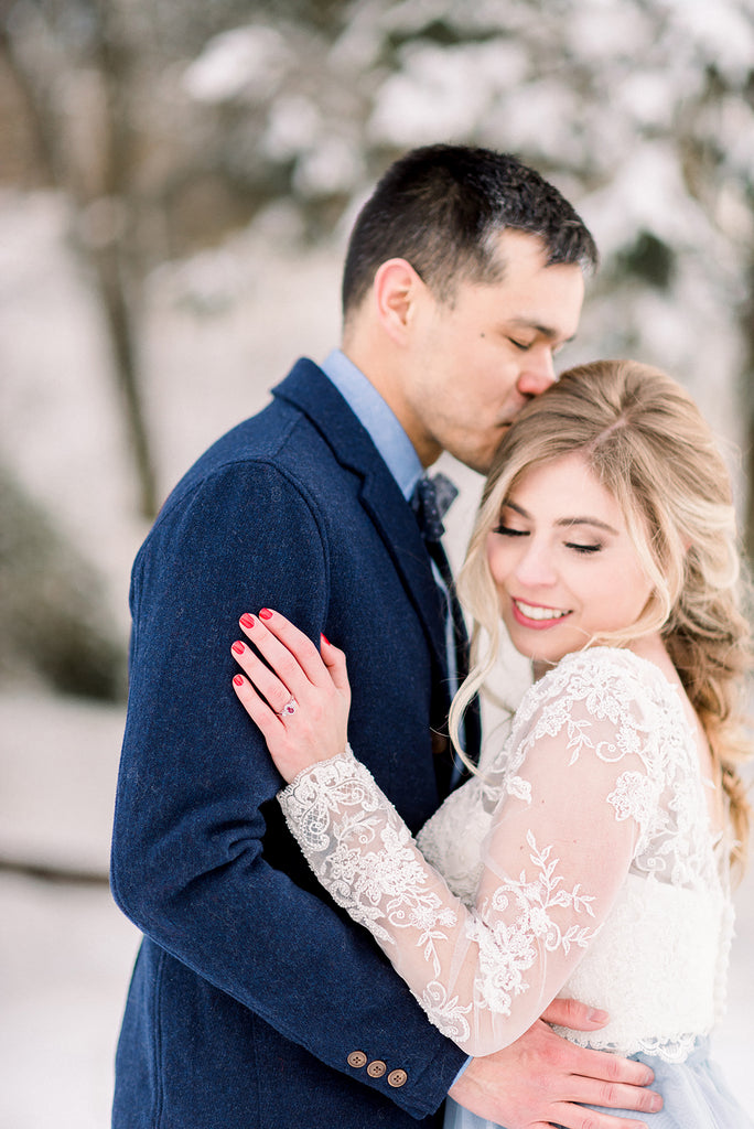 bride and groom embrace in winter wedding