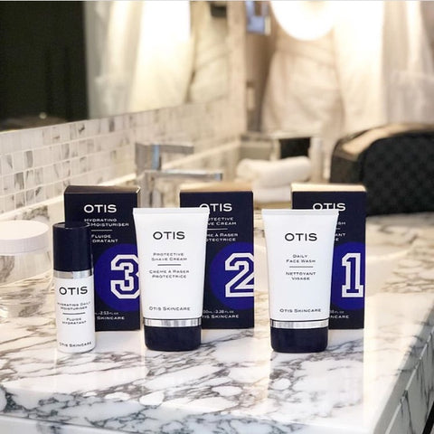 Otis Skincare products for men - in marble bathroom with LV wash bag