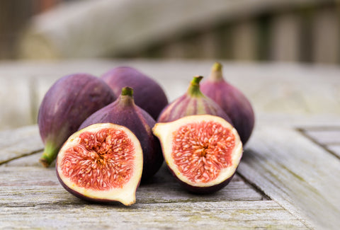 Phytonutrients: Eat The Rainbow for Healthy Skin. Cut figs on a wooden table