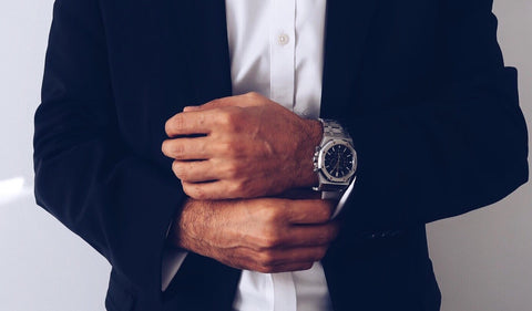 Man with beautifully manicured hands in a dark blue suit 