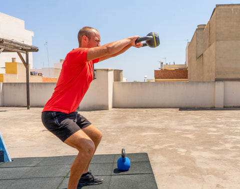 10 Reasons Strength Training Is So Good For You - man using weighted kettle bell