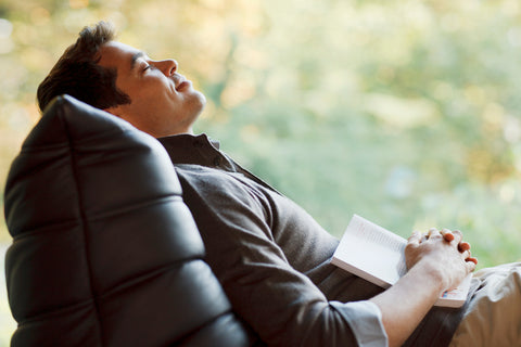 The Art of taking a Proactive Nap. Man sleeping reclining in a chair