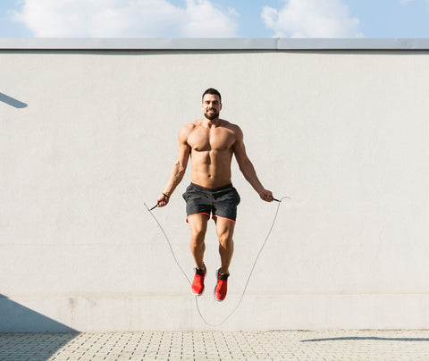 Top 3 workouts for a flatter stomach. HIIT workout. Man skipping rope.