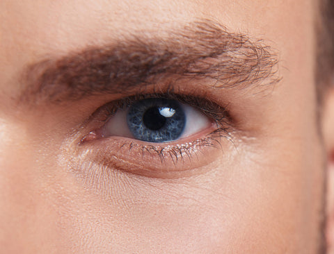 Getting rid of under eye wrinkles. Close up of handsome man with smooth skin under eyes