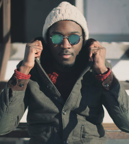 Handsome bald black man wearing a beanie hat in winter