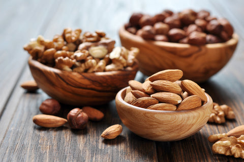 Almonds, walnuts and hazelnuts in wooden bowls