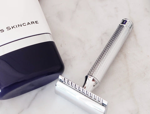 Your Anti Aging Shaving Routine. Shave Cream and razor with chrome handle on marble