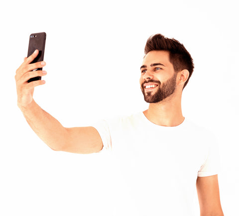 Handsome man smiling and taking a selfie photo