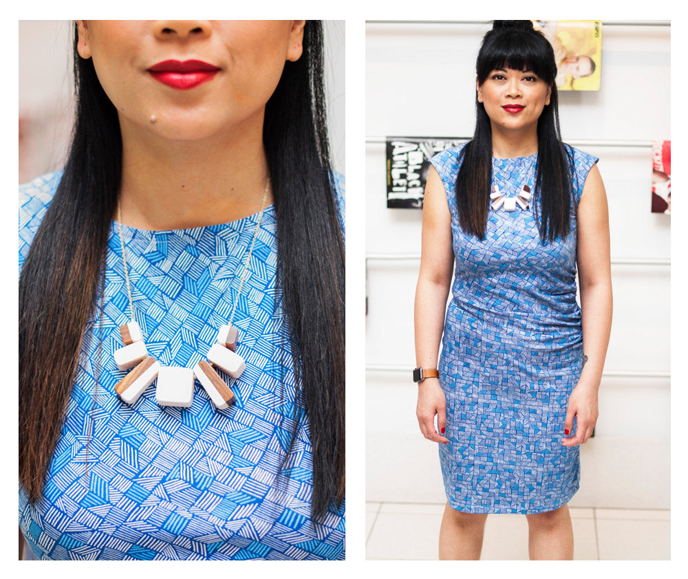 Bernadette wearing the First Impressions dress in blue lines and the Two Tone Block necklace in white.