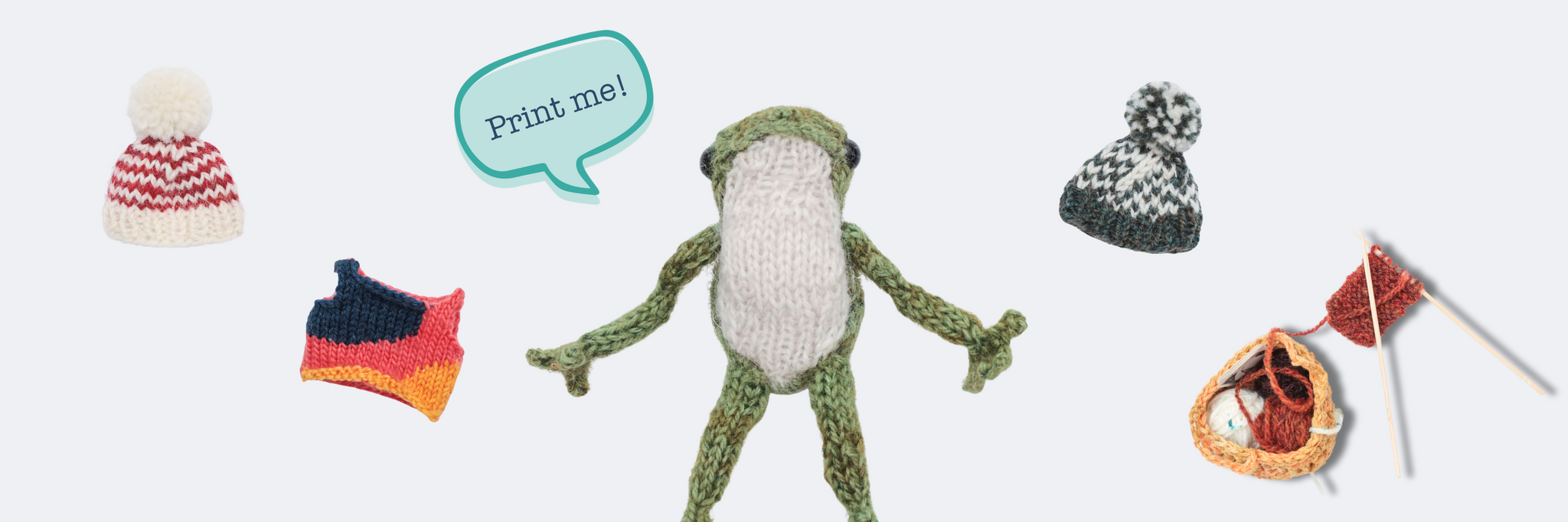 A picture of paul the frog surrounded by knitted hats, a top, and knitting project bag. He has a speech bubble to the left saying "print me" in blue text