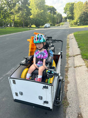 Child in power wheelchair in Bunch Bike