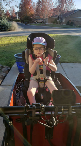 Child with developmental disability in bike with medical equipment