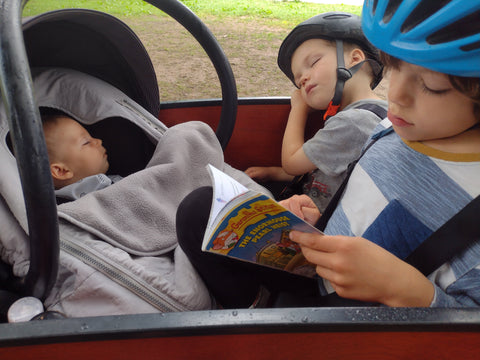 Baby in car seat adapter with two older kids in original bunch bike