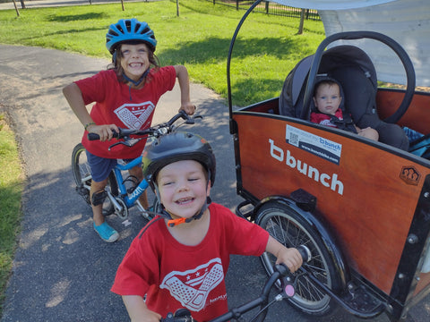 Baby in Bunch Bike with big kid on bike and toddler on balance bike