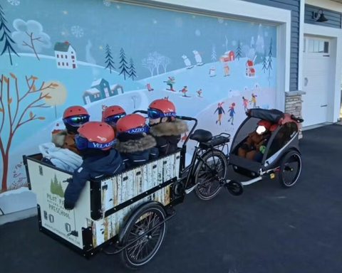 Kids in preschool bunch bike with helmets