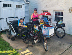 Mom and two kids with bunch bike, longtail bike, and more