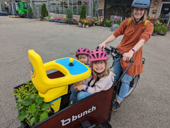 Two kids and Explorer Mini and some plants in bunch bike