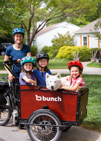 Three kids and a dog in the Original Bunch Bike