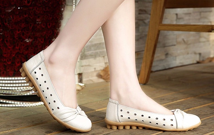 side shot of a beautiful woman with pretty legs wearing the nodule bowtie style shoes