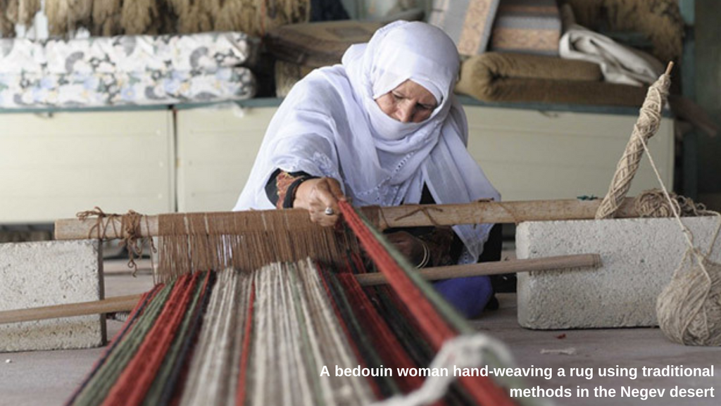 Bedouin woman hand weaving using traditional methods in the Negev dessert - Palestine