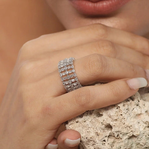 An image of a woman's finger wearing CZ finger rings