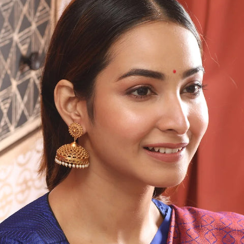 An image of a woman wearing a pearl jhumkas