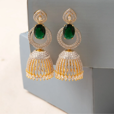 A picture of a pair of Indian earrings with Cubic Zirconia and green gemstones