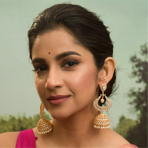 A picture of a woman wearing an Indian earrings with Cubic Zirconia
