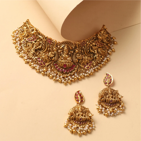 An image of an Indian choker with divine motifs with goddess Laxmi