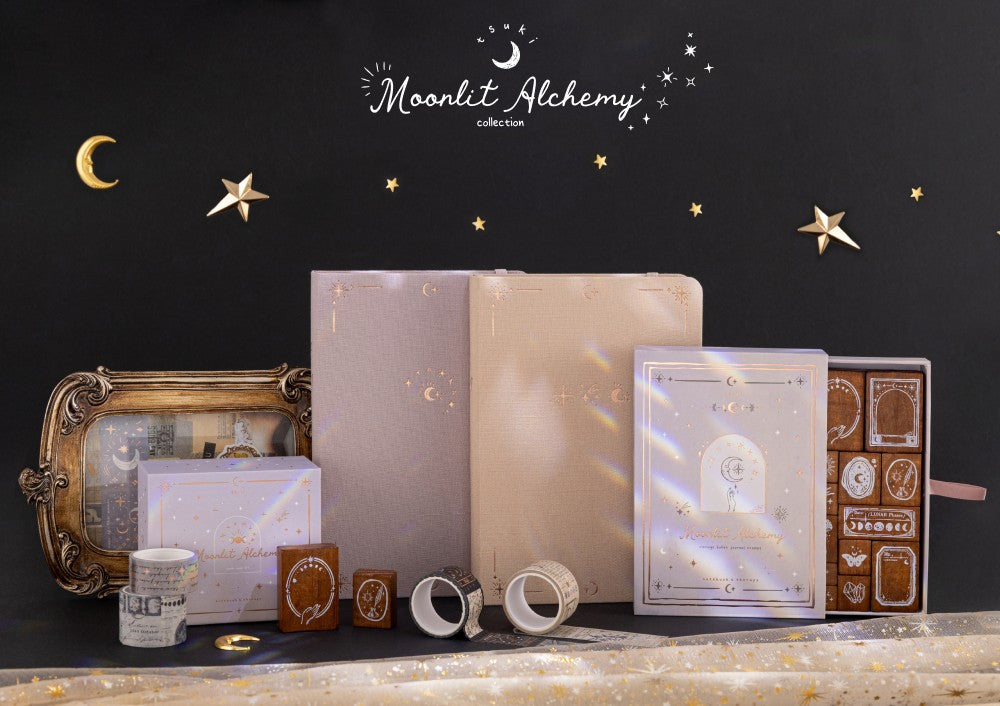 Moonlit Alchemy collection against black background including Stardust Dawn bullet journal, Moonlit Dusk bullet journal, Moonlit Alchemy stamps and washi tapes with witchy decorations