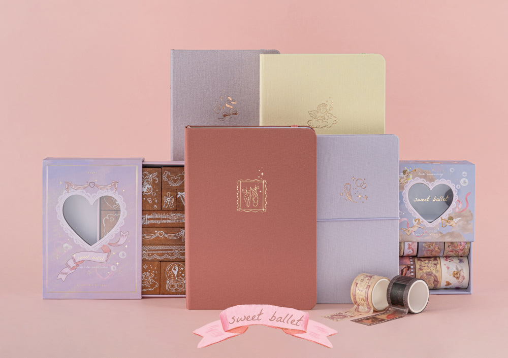 Flatlay of Tsuki Sakura Breeze Travel Notebook Gift Set on pink background