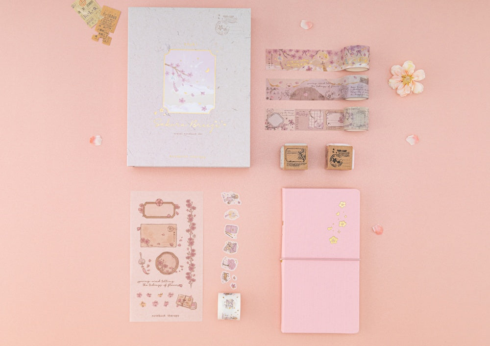 Flatlay of Tsuki Sakura Breeze Travel Notebook Gift Set on pink background