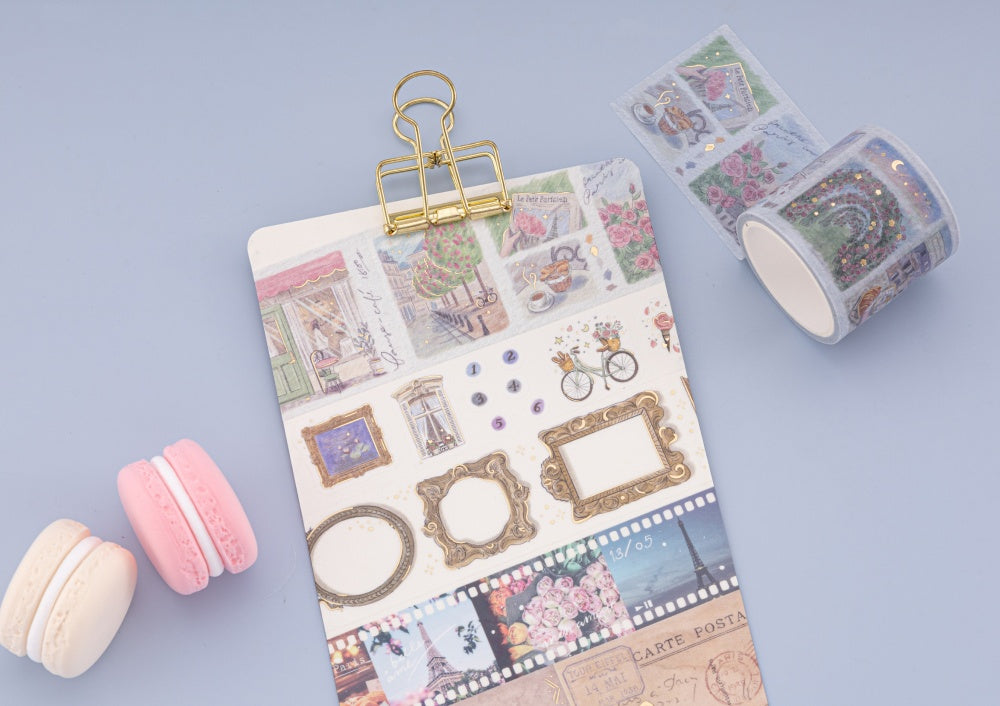 Kraft paper card with gold clip and washi tape swatch on pink background with a magnifying glass