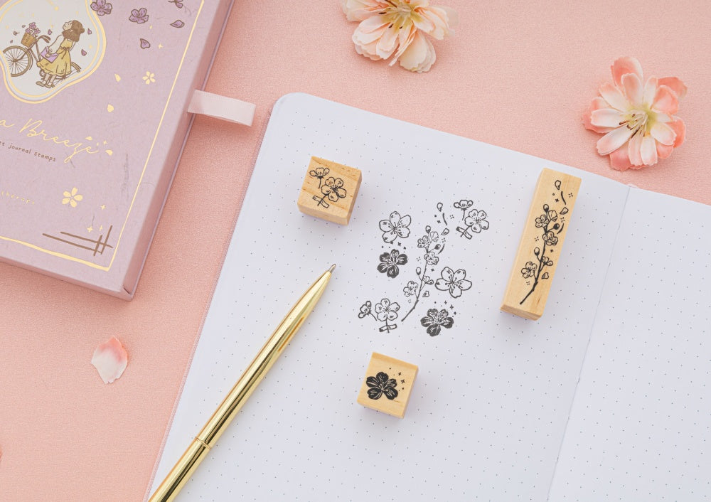 Tsuki Love Lock collection including key bullet journal, washi tape set and stamp set with flowers in the background