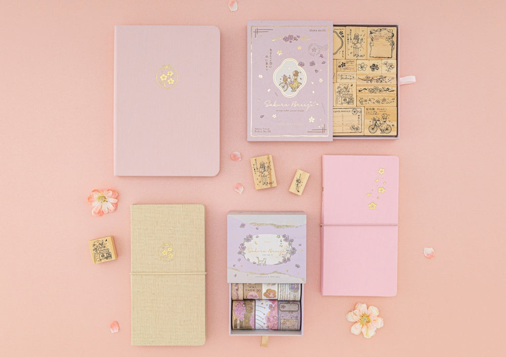 Flatlay of Sakura Breeze travel notebook gift set, kraft paper trave notebook, bullet journal and washi tapes