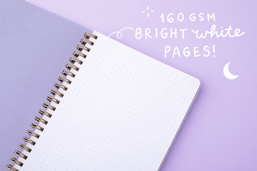 Close up on tsuki Floral lilac taro notebook with open 160 gsm white pageson lilac background