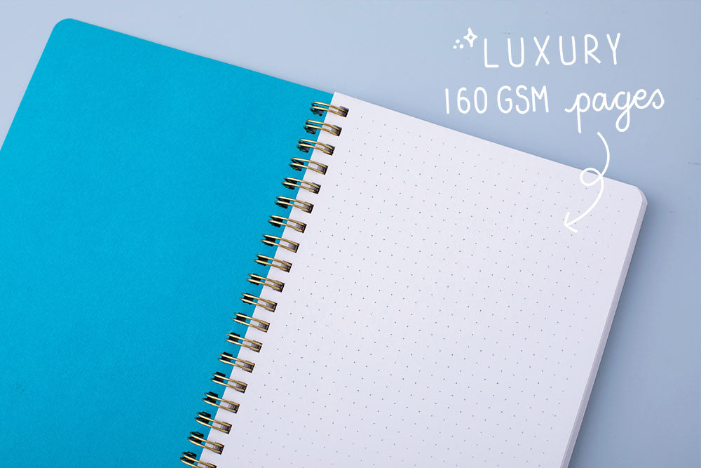 Tsuki Ocean Edition Ring Bound notebook in aqua blue open with luxury 160GSM pages on blue background
