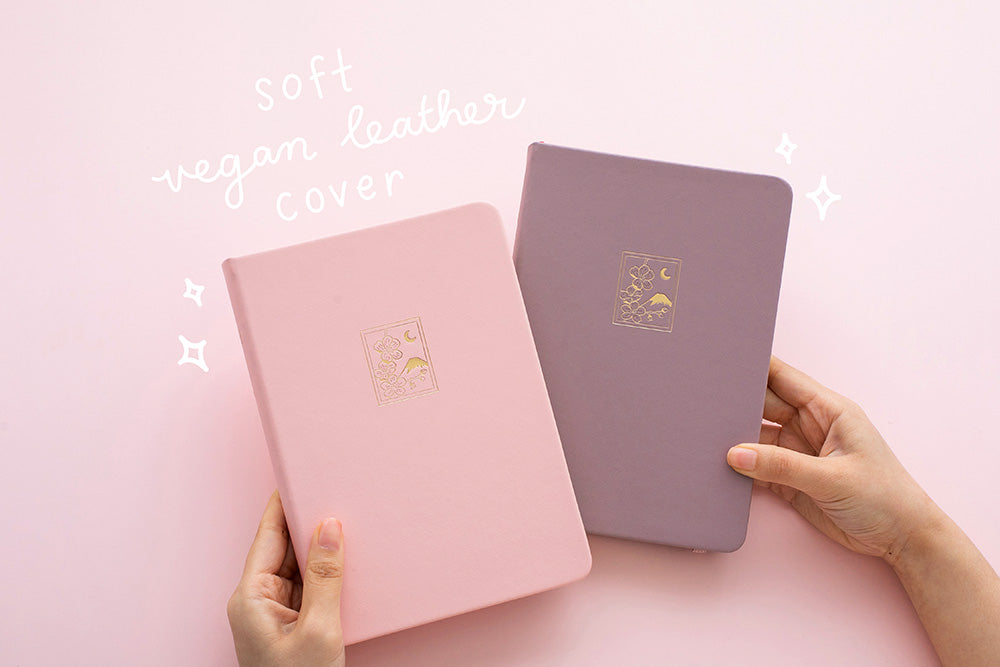 Blush pink and petal pink sakura themed bullet journal notebooks with soft vegan leather cover on pink background